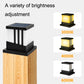 Solar column lamp with black housing and frosted sides, showing warm yellow glow