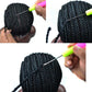 Black braided dreadlock net cap detail with needle tool for attaching braids.