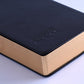 A5 diary notebook close-up: black cover with embossed logo, hardback spine