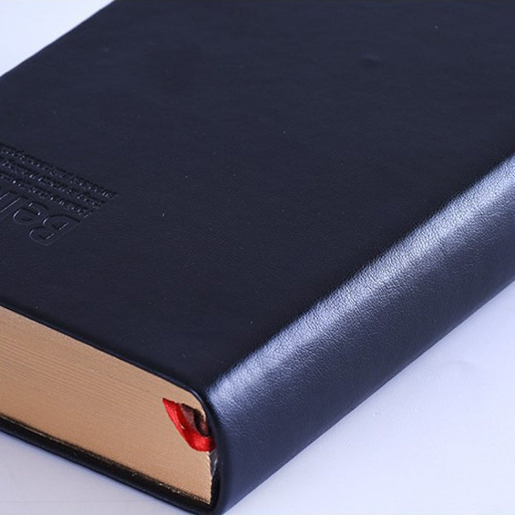 A5 diary notebook corner close-up with red ribbon bookmark and black cover