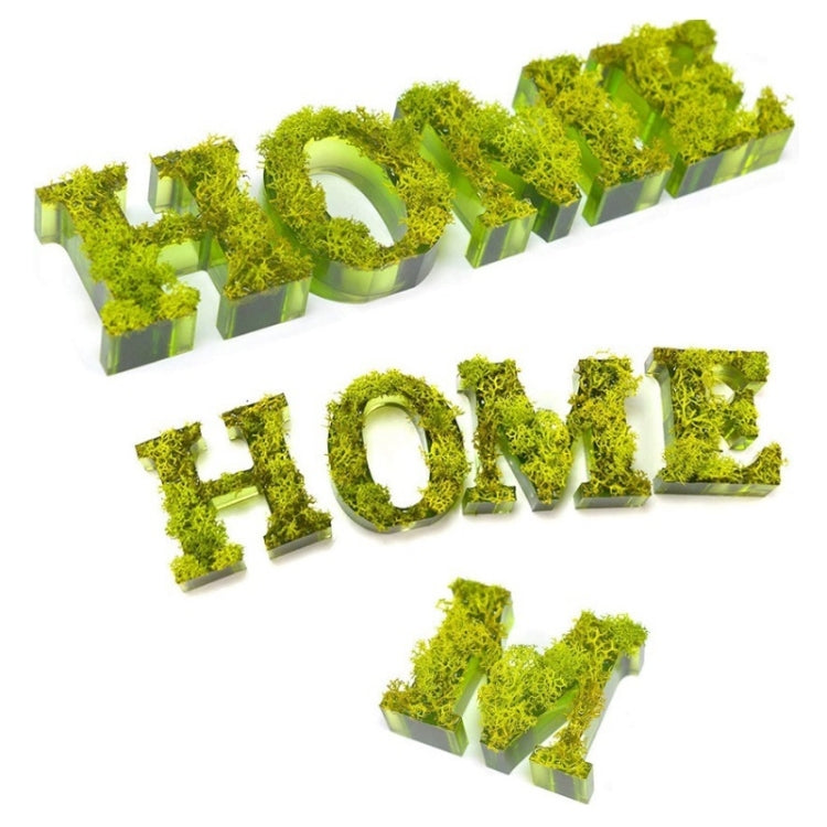 Green glitter resin letter keychain charms arranged in rows