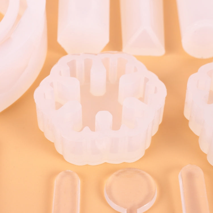 Silicone mold tray close-up showing round floral pendant cavity and heart cavity