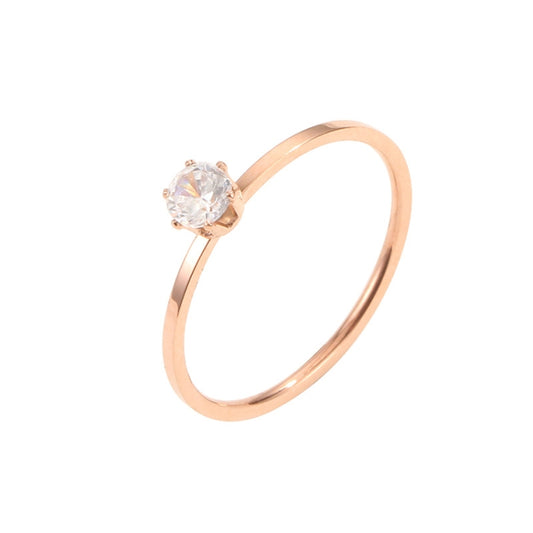 Rose gold-tone diamond ring with round center stone in six-claw setting