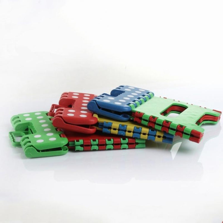 Stacked kids plastic folding stools with colorful interlocking panels and polka-dot tops