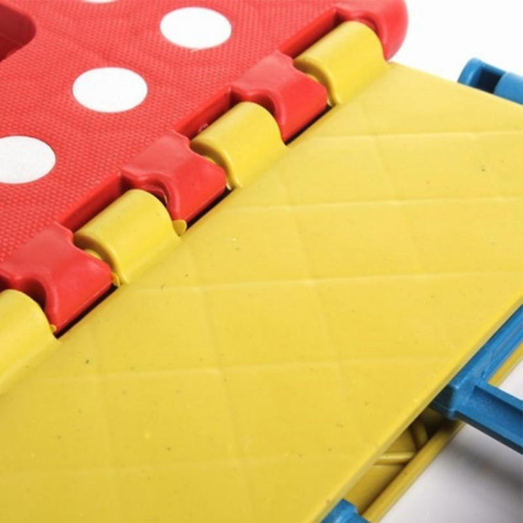 Close-up of kids plastic folding stool interlocking edges on red and yellow panels