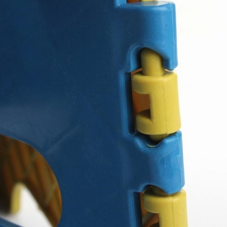 Close-up hinge and lock of blue kids plastic folding stool with yellow connector parts