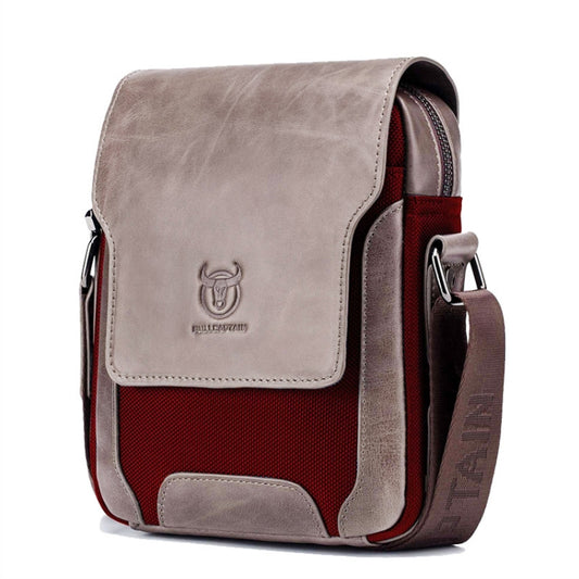Leather diagonal shoulder bag with flap, light gray exterior, red panel, and metal buckles