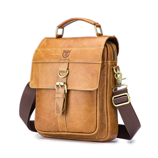 Tan leather shoulder bag with front flap, top handles, and adjustable crossbody strap
