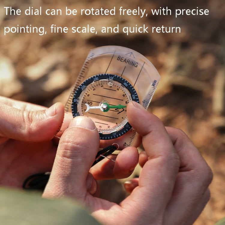 2-in-1 outdoor compass close-up, dial adjusted by fingers; clear body