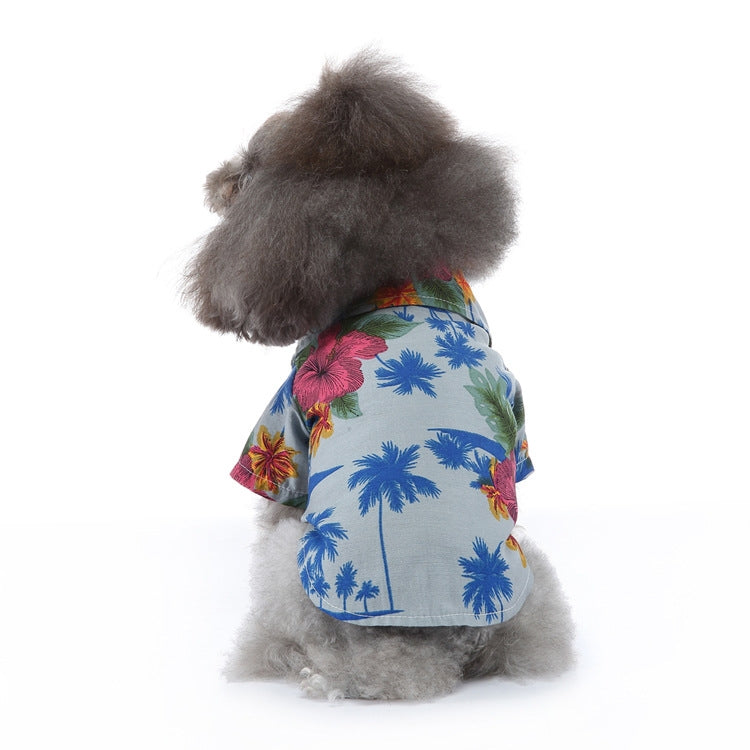 Dog summer shirt with blue palm tree print and floral accents on light blue.