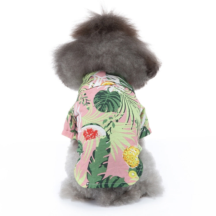 Dog summer shirt with tropical leaf and fruit print on pastel pink and green.
