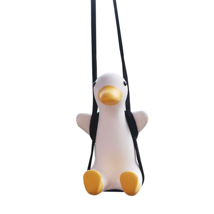White duck car pendant with yellow beak and feet, hanging from two black cords