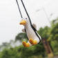 Duck car pendant in side view with yellow beak and feet, hanging from black cords