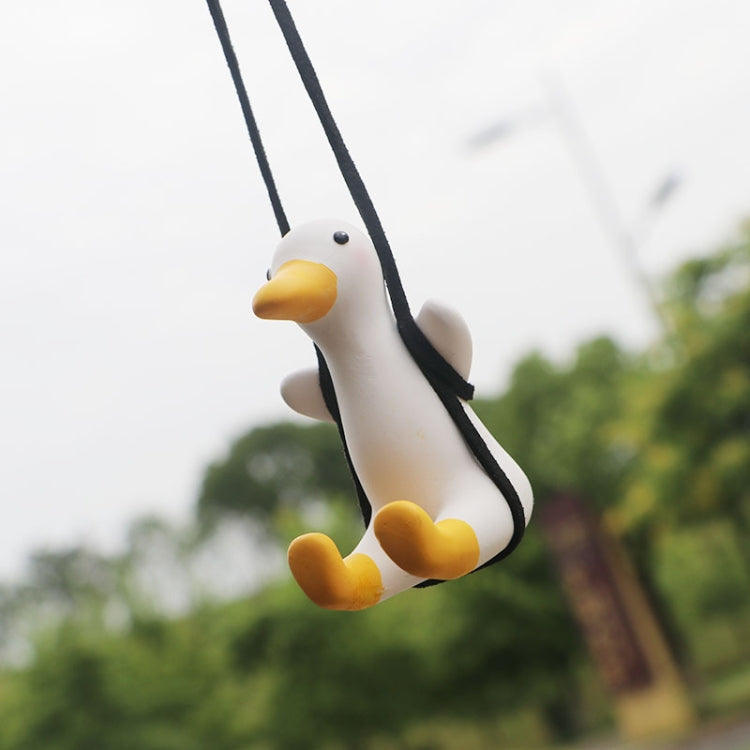 Duck car pendant in side view with yellow beak and feet, hanging from black cords