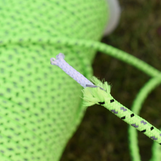Close-up of luminous tent rope with knot detail, 4mm neon green braided texture