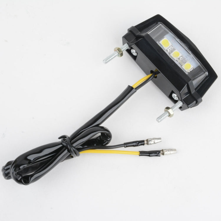 Motorcycle LED license plate taillight light with black mount bracket and wiring harness