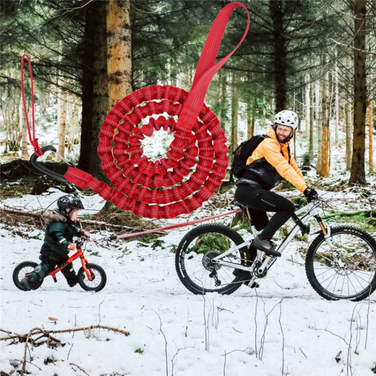 Red coiled bicycle tow rope with handle loop and carabiner connector