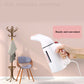 Mini handheld garment steamer with cord, used to steam clothes on the go