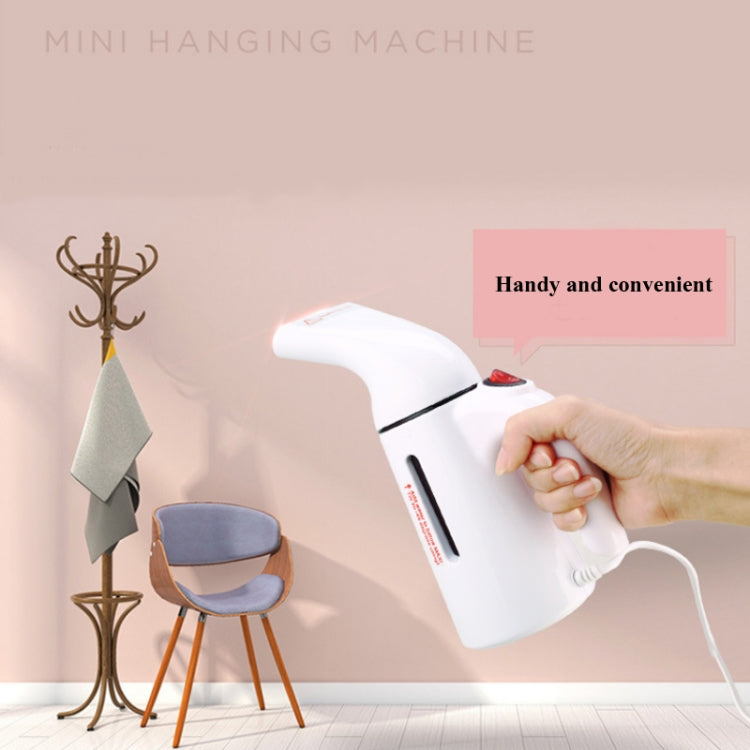 Mini handheld garment steamer with cord, used to steam clothes on the go