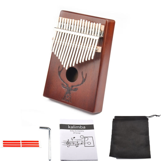 Deer head kalimba thumb piano with 17 tines, included accessories laid out nearby