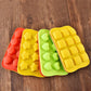Silicone ice cube mold tray with multiple shaped cavities in red, yellow, and green