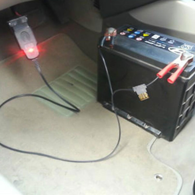 OBD power memory saver connected to a car battery with clamp and adapter lead