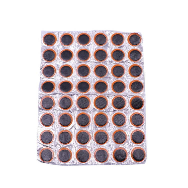 Round tire repair patch sheet with 48 black-and-orange circular patches