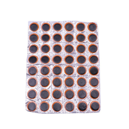 Round tire repair patch sheet with 48 black-and-orange circular patches