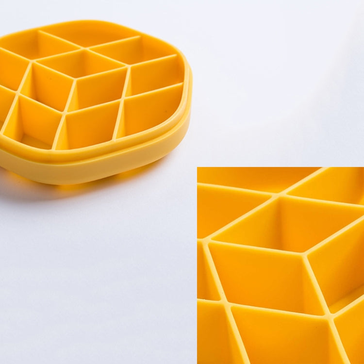 Close-up of yellow hexagonal ice cube mold compartments in tray
