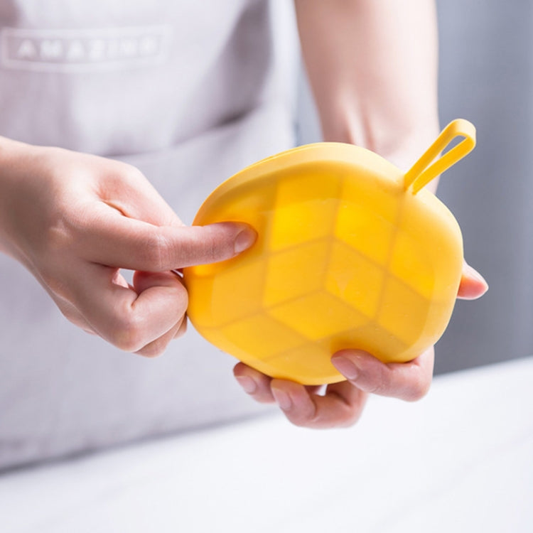 Yellow hexagonal ice cube tray held by hands with compartment pattern