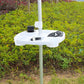 White umbrella cup holder tray mounted on pole outdoors with cups and accessories
