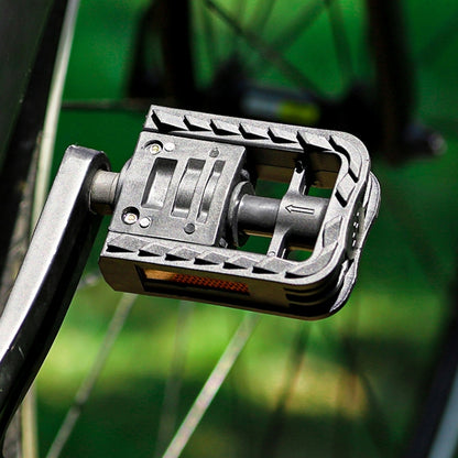 Folding bicycle pedal with ball axle and metal crank arm, black and silver close-up