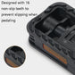 Black folding bicycle pedal with non-slip teeth and orange side reflector, close-up