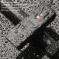Weatherproof black bicycle speaker and lamp unit on wet surface