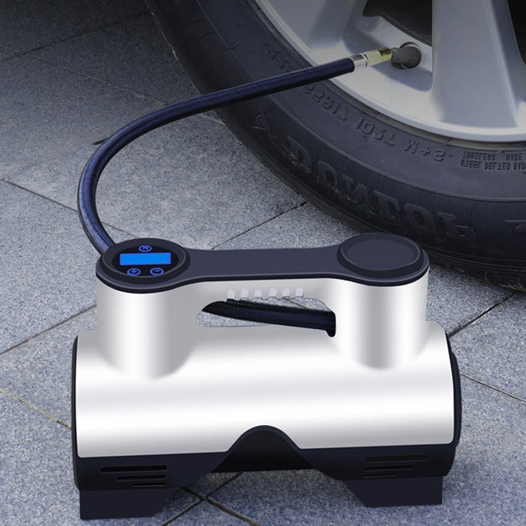 Compact car tire inflator pump on ground with control panel and connected power cable
