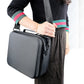 Person carrying gray hard shell storage bag by the shoulder strap