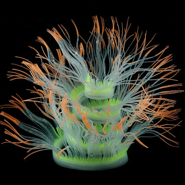 Fluorescent simulated coral anemone with blue tentacles and orange tips, green glow center