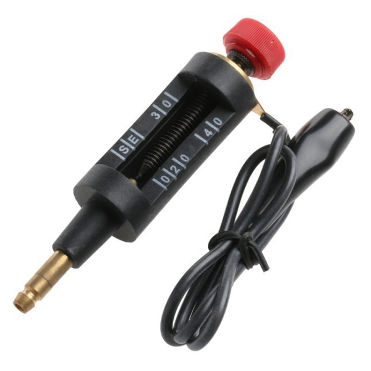 Spark plug test pen with brass tip, red cap, and attached black power cable