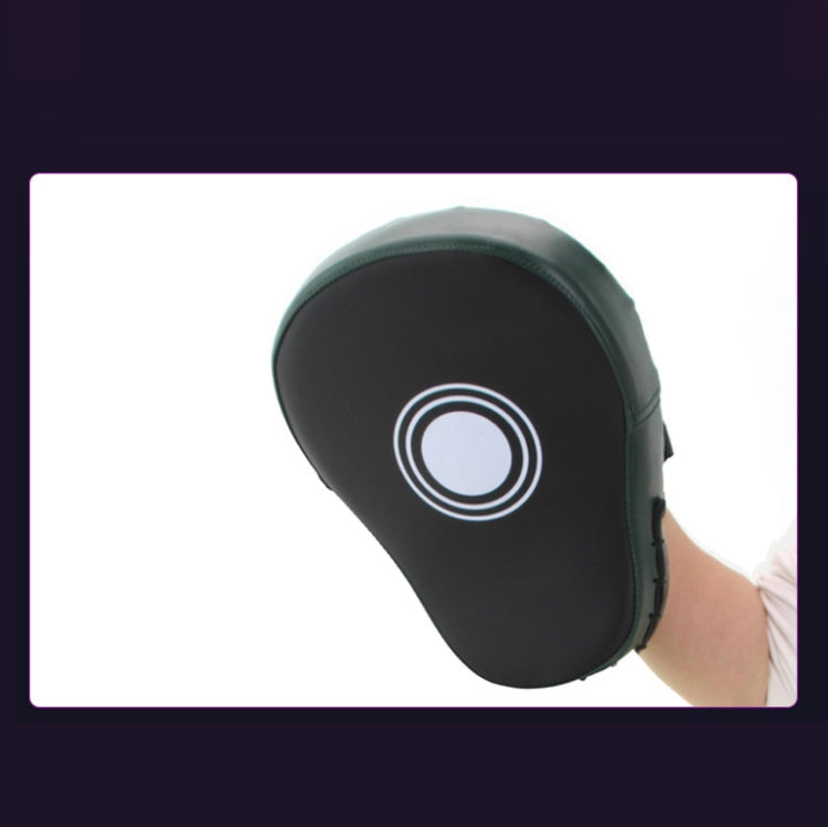Black leather hand target with white target circle graphic held in a hand