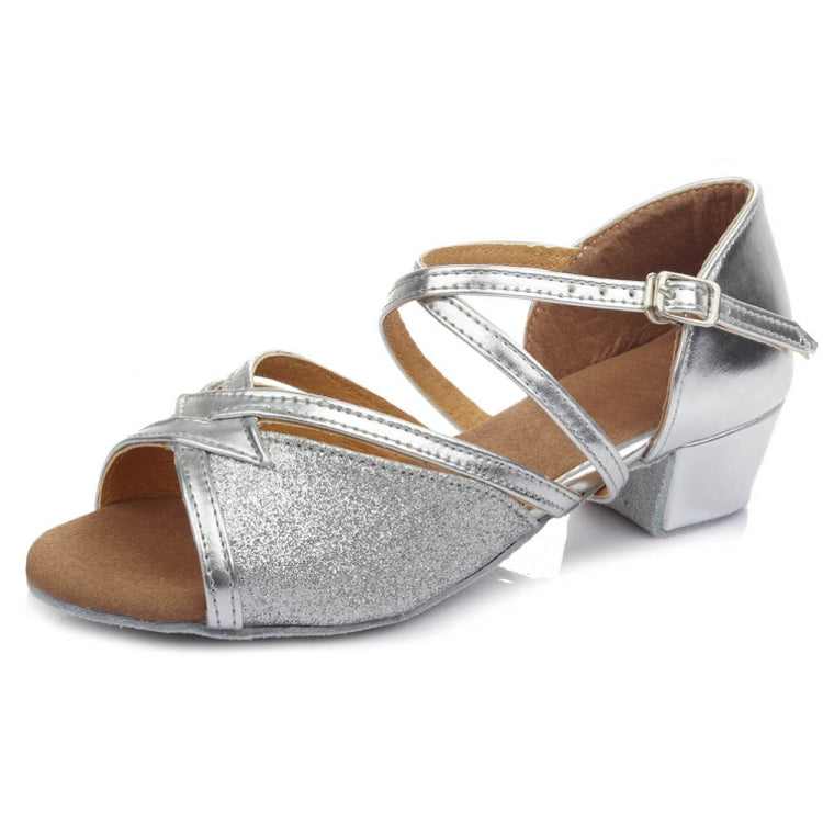 Silver glitter low-heel dance shoes with ankle buckle and soft sole.