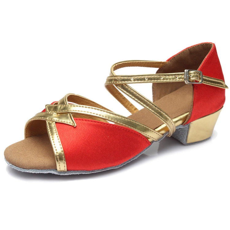 Red and gold low-heel dance shoes with ankle buckle and soft sole.