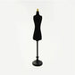 Mini black dress form mannequin with gold top and black round base for dollhouse display