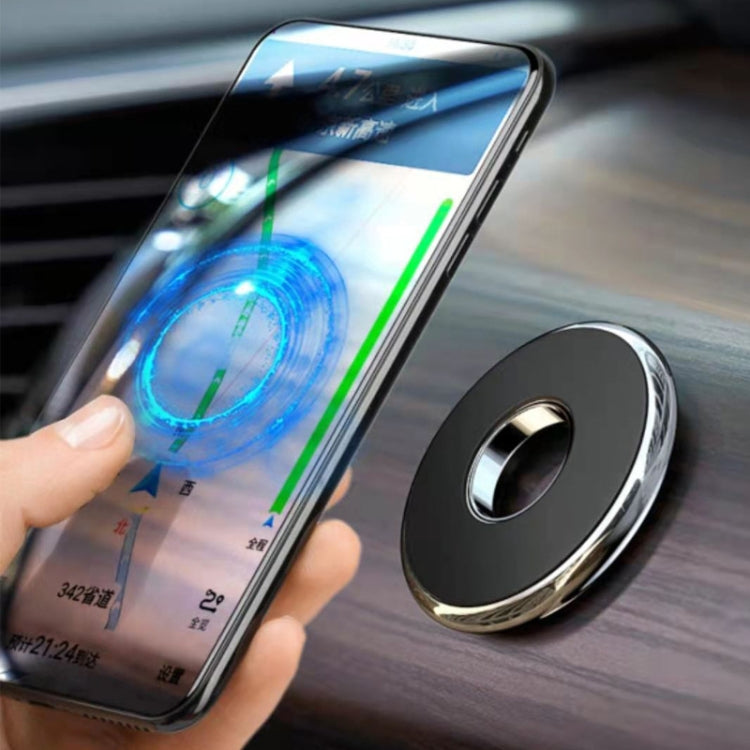 Round magnetic car phone holder next to smartphone, black base with silver rim