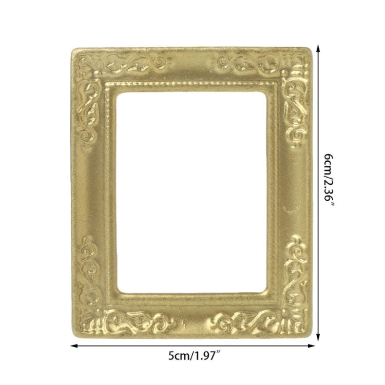 Miniature gold dollhouse picture frame with ornate border and size markings