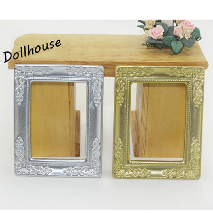 Pair of miniature dollhouse picture frames in silver and gold with ornate borders