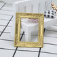 Miniature gold dollhouse decorative frame with ornate edge and empty window