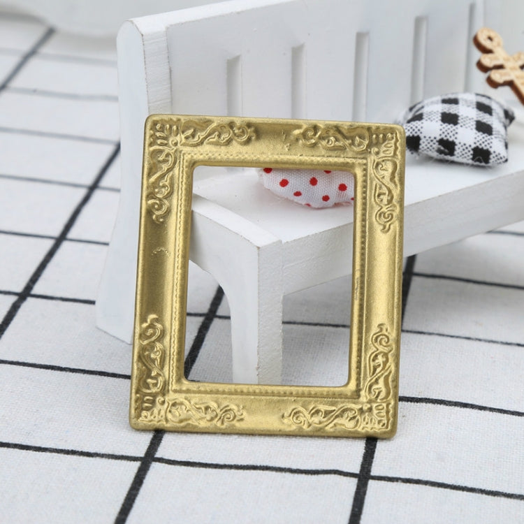 Miniature gold dollhouse decorative frame with ornate edge and empty window