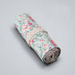 Floral canvas pen roll pouch, rolled up with pink-beige fabric band; pastel blue floral.