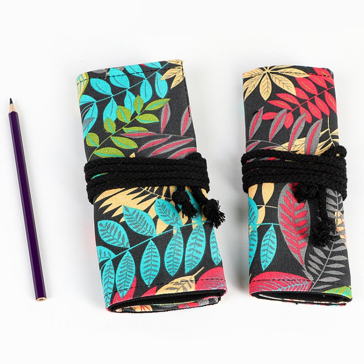 Two folded leaf-print pen roll cases with black ties, shown with a pencil beside