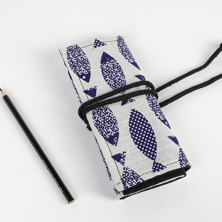 Close-up of tied canvas pencil roll with blue-and-white fish pattern and black cord